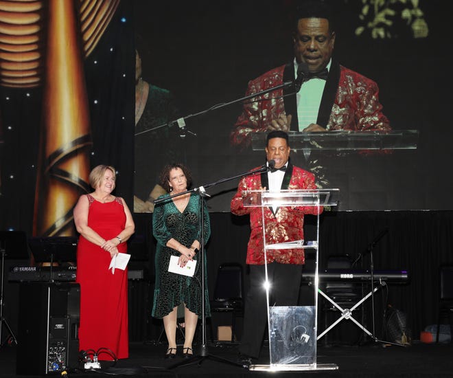 (L) Julie Leach, Executive Director, Debra Flynt-Garrett, Development Director, and Founder and Artistic Director Nate Jacobs welcome their guests. The Westcoast Black Theatre Troupe’s 22nd Anniversary Gala was held on Saturday, December 4, 2021 at the Circus Arts Conservatory’s Sailor Circus Arena in Sarasota, Florida. The event titled “A Night at the Savoy” turned the arena into a replication of New York City’s famous Harlem public, no-discrimination ballroom, The Savoy, which was in operation from 1926 – 1958. WBTT uses funds for education, artist development and a mentoring program geared toward underserved young people.