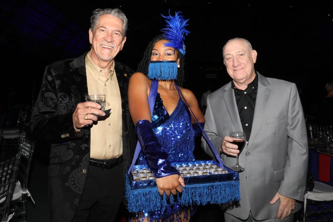 (L) Dr. Ai Streacker and Dennis Rees pose with WBTT Artist Katherine Taylor of Atlanta. The Westcoast Black Theater Troupe’s 22nd Anniversary Gala was held on Saturday, December 4, 2021 at the Circus Arts Conservatory’s Sailor Circus Arena in Sarasota, Florida. The event titled “A Night at the Savoy” turned the arena into a replication of New York City’s famous Harlem public, no-discrimination ballroom, The Savoy, which was in operation from 1926 – 1958. WBTT uses funds for education, artist development and a mentoring program geared toward underserved young people.