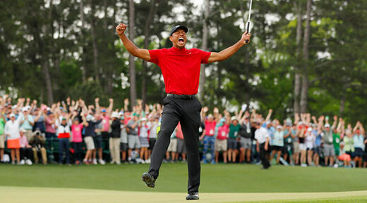 Tiger Woods of the United States celebrates after sinking his putt on the 18th green to win during the final round of the Masters at Augusta National Golf Club on April 14, 2019 in Augusta, Georgia.