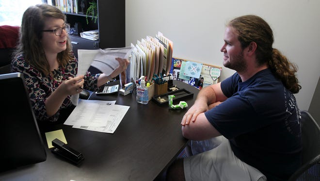 Emily Buis, a guidance counselor, meets with Daniel Newton to pick classes for the next semester. Georgia State University, an urban university in Atlanta, and a peer institution much like UWM, has struggled with low graduation rates. They have implemented a program with rigorous counseling, peer and academic support, that promises to graduate incoming students in four years.