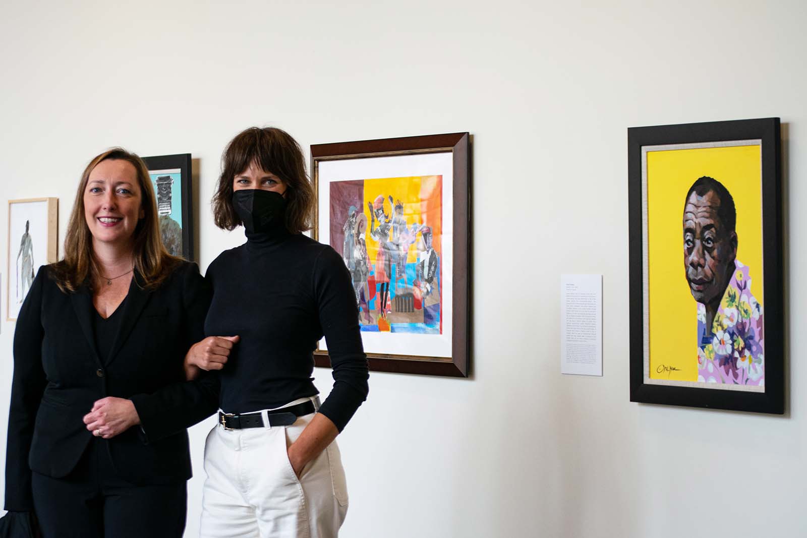Assistant Professor of Art and Art History Hannah Ryan (left) and Flaten Art Museum Director Jane Becker Nelson '04 stand before the pieces of art acquired through the Art Now course.