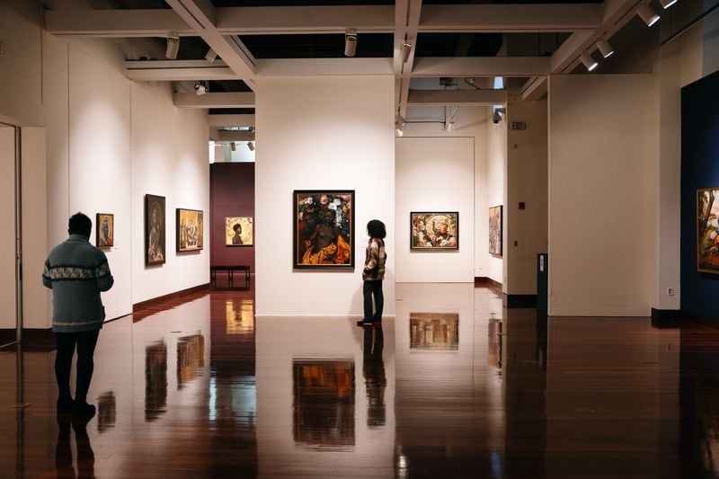 Visitors to the Spelman College Museum of Fine Art take in the Afro-Cuban Harmonia Rosales' Master Narrative exhibit last November. (Olivia Bowdoin for the Atlanta Journal-Constitution)