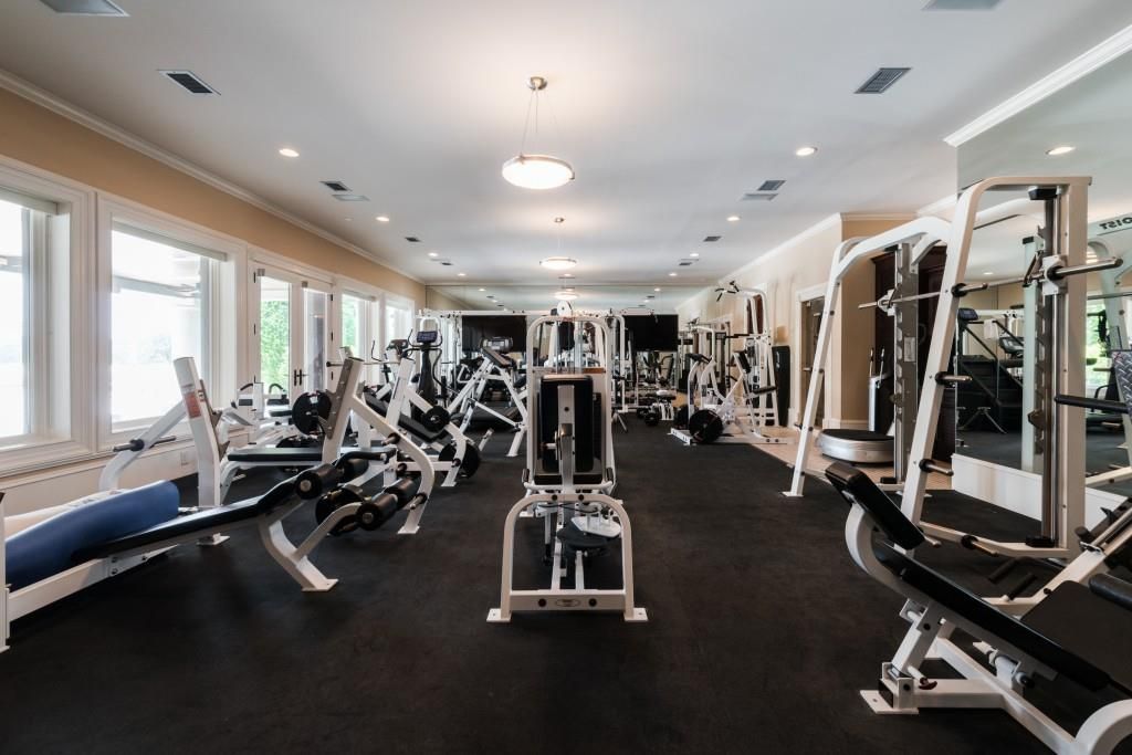  A home gym is fully equipped with machines and weights