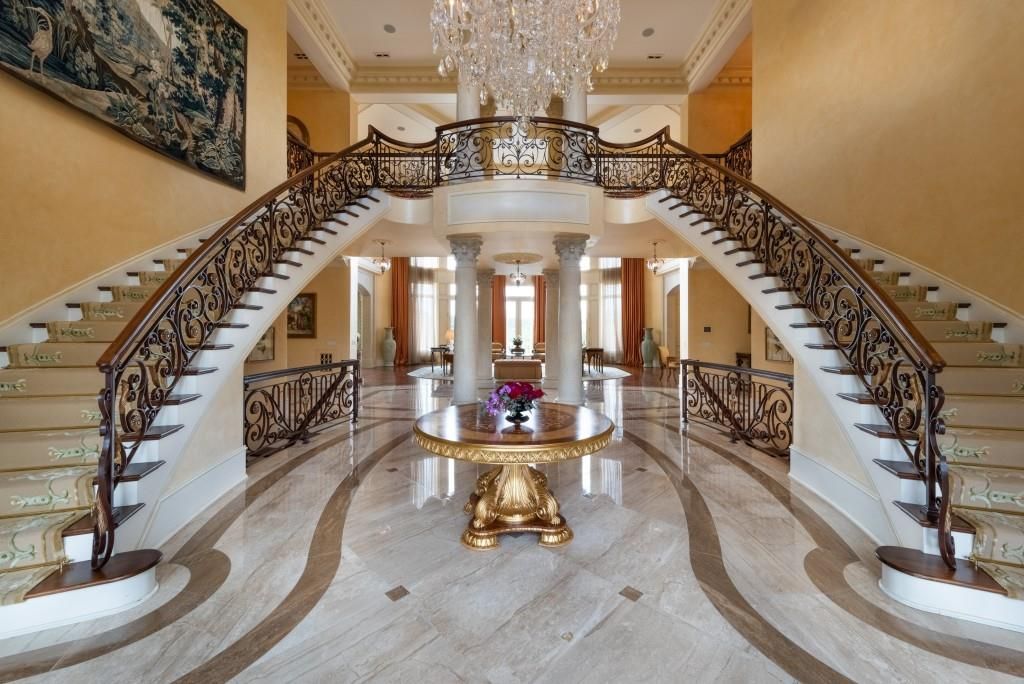 Upon entry, a grand imperial staircase is in the front of the home