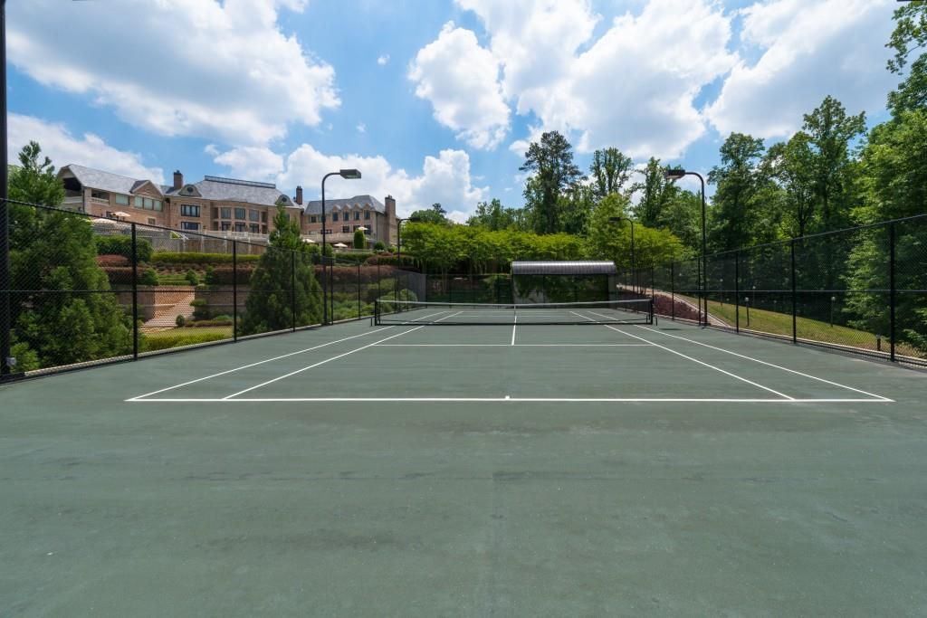  A full-size tennis court sits below the home on the multi-layer property