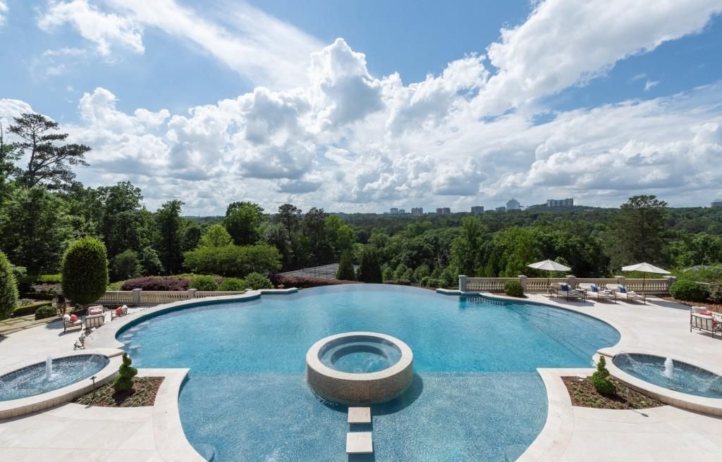  A 70,000 gallon infinity pool looks over the green 17 acre property